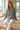 Model sitting in the palm-print pajama top