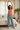 Model stretching in palm-print pajama pants