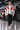 Model walking forward through the motorsport garage