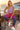 Model wearing tropical joggers at a seaside café