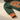 Orange cuff and forest green knit close-up