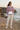 Pink hoodie styled with ivory joggers and white sneakers