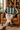 Regenerated reading-chair look using the forest-green and cream knitted sweater reference