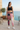 Rose-print leggings with black athletic top at coastal café