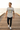 Sand graphic tee and distressed jeans on a seaside pier