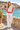 Seaside promenade with white linen trousers
