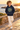 Six-year-old in navy hoodie on a coastal walkway