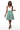 Skirt with white silk camisole and gold jewelry