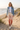 Sunset joggers with denim jacket on dune boardwalk