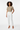 T-shirt with white tailored pants and pumps