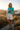 Teal shirt on a rugged Pacific coast