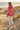 Tie-dye hoodie back detail on golden-hour beach dunes
