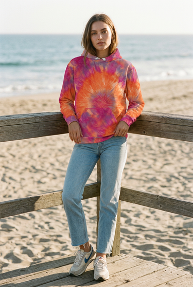 Tie-dye hoodie styled on a beachside boardwalk