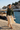 Trailhunter hoodie with a cream midi skirt at a marina