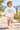 Two-year-old in white hoodie on a beach boardwalk