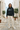 Vintage Black hoodie with cream wide-leg trousers in a coastal alley
