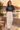 Washed-black Surfxion crop top styled with ivory trousers