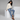 Woman in Jaguar Blue leopard print joggers with cream knit sweater