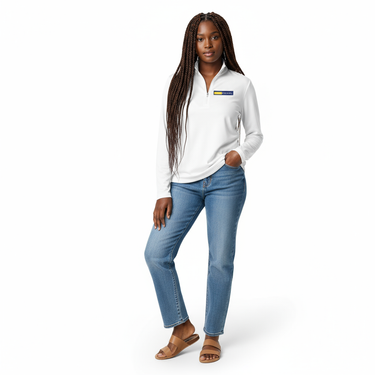 Woman with braided hair in white lightweight quarter-zip pullover with light blue jeans