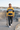 Yellow and navy hoodie styled with charcoal jeans at a skate plaza