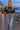 Your model in the washed-black crop top on a seaside boardwalk