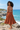 Back-view editorial at a coastal overlook