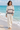 Barefoot beach look with cream linen trousers