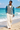 Barefoot beach look with cream linen trousers
