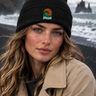 Black beanie on volcanic shore