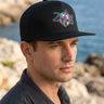 Black cap three-quarter coastal editorial