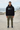 Black hoodie with olive cargo trousers at a coastal skatepark