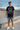 Black tee with denim shorts without beanie