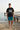 Black tee with teal board shorts