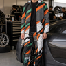 Blond model leaning against a sports car in the matching set