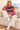 Blonde female model in a cozy sofa look with cream trousers