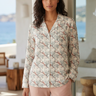 Botanical pajama top styled with blush trousers
