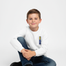 Boy sitting in white sweatshirt