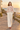 Brunette model in the sweater on a beach boardwalk