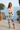 Camo joggers styled with an ivory camisole and cream blazer
