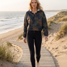 Cropped windbreaker with black leggings on coastal dunes