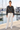 Cropped windbreaker with ivory trousers at marina
