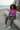 Curly-haired model wearing the tropical hoodie with joggers