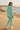 Female editorial showing the hoodie’s back with matching mint joggers