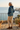 Female hoodie rear-view editorial on coastal terrace