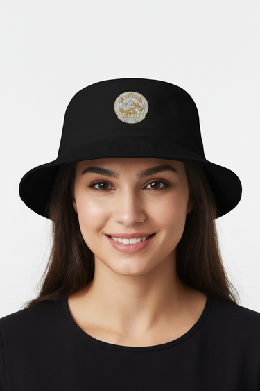 Female model close-up wearing black bucket hat smiling