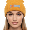 Female model close-up wearing gold beanie