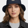 Female model close-up wearing navy bucket hat