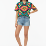 Female model in denim shorts and white sneakers