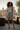 Female model in grey mountain graphic tee and sage shorts