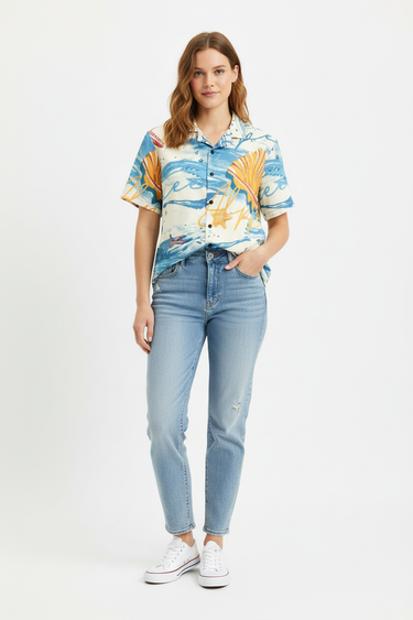 Female model in light wash jeans and white sneakers